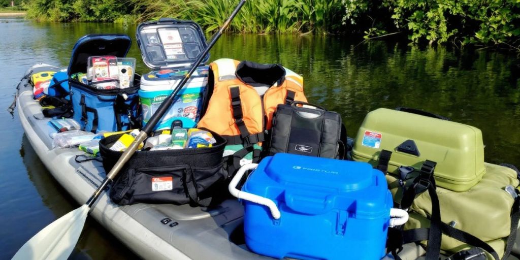 Kayak fishing accessories like rod, tackle box, and cooler.