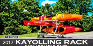 A kayak rolling rack with kayaks outdoors in nature.