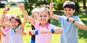 Kids exercising with resistance bands and dumbbells outdoors.